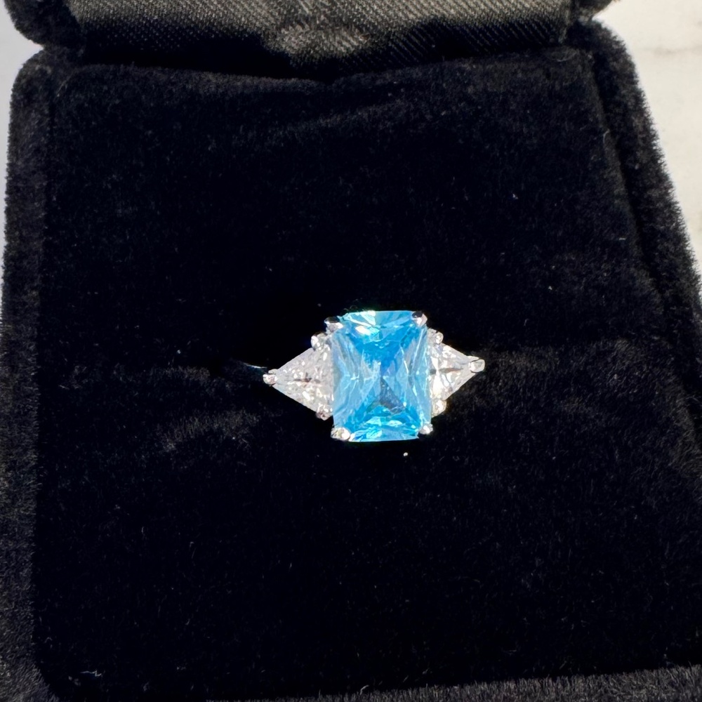 Blue radiant cut cubic zirconia with 2 white cz marked 925 RSC silver ring.